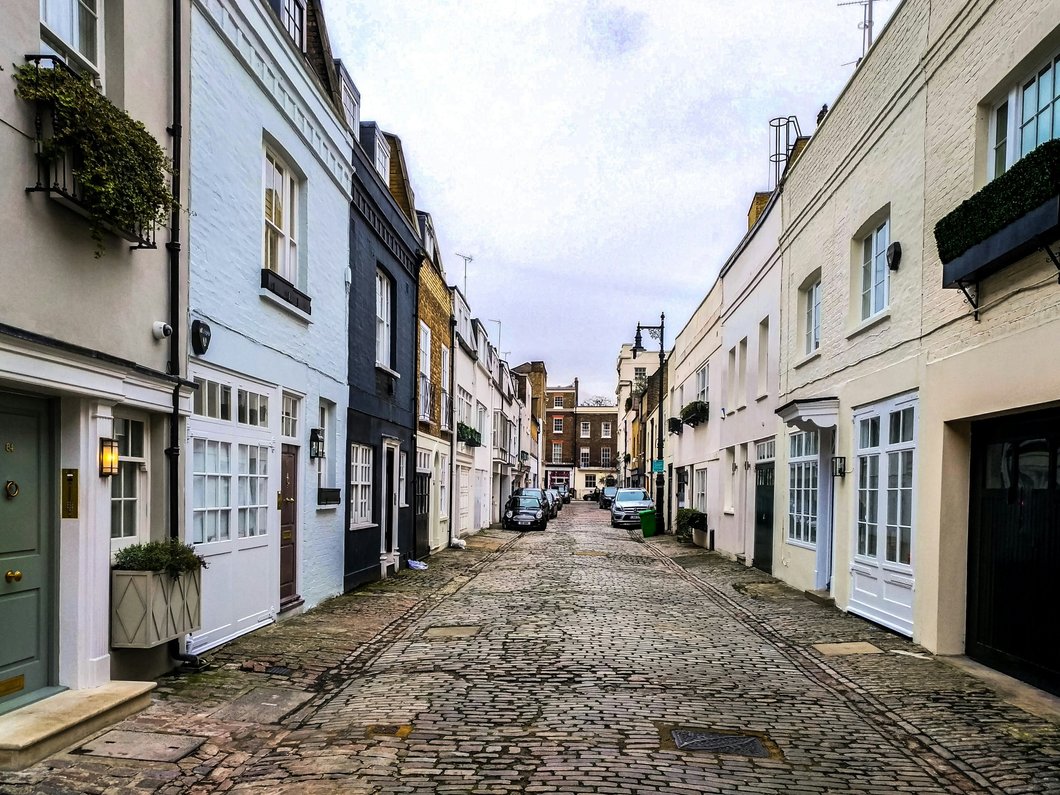 white and brown concrete buildings under white clouds during daytime