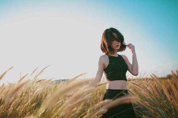 woman alone standing in wheat field