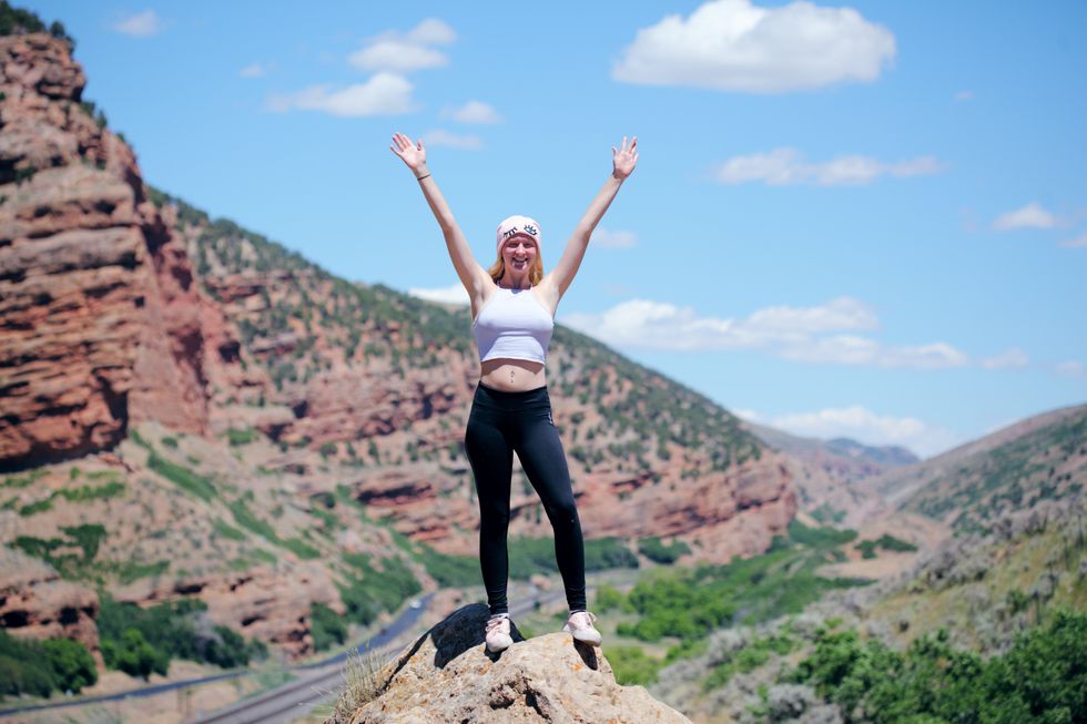 woman celebrates on hiking trail