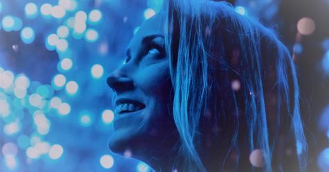 woman glows in blue light