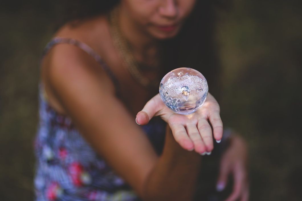 woman holding crystal ball