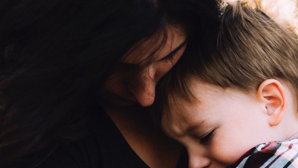 Woman holding her face in her hands