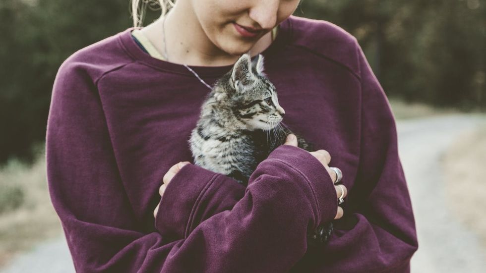 woman holding kitten