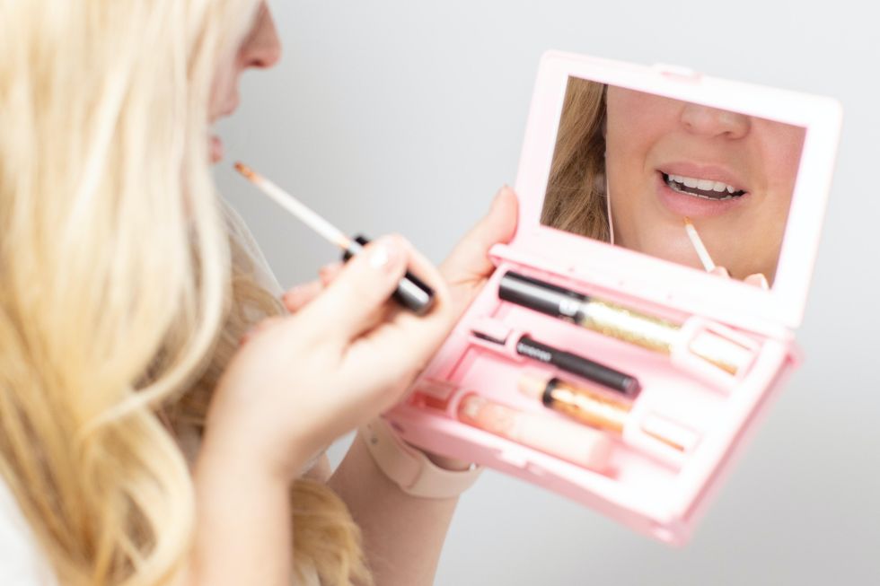 woman holding lip gloss set