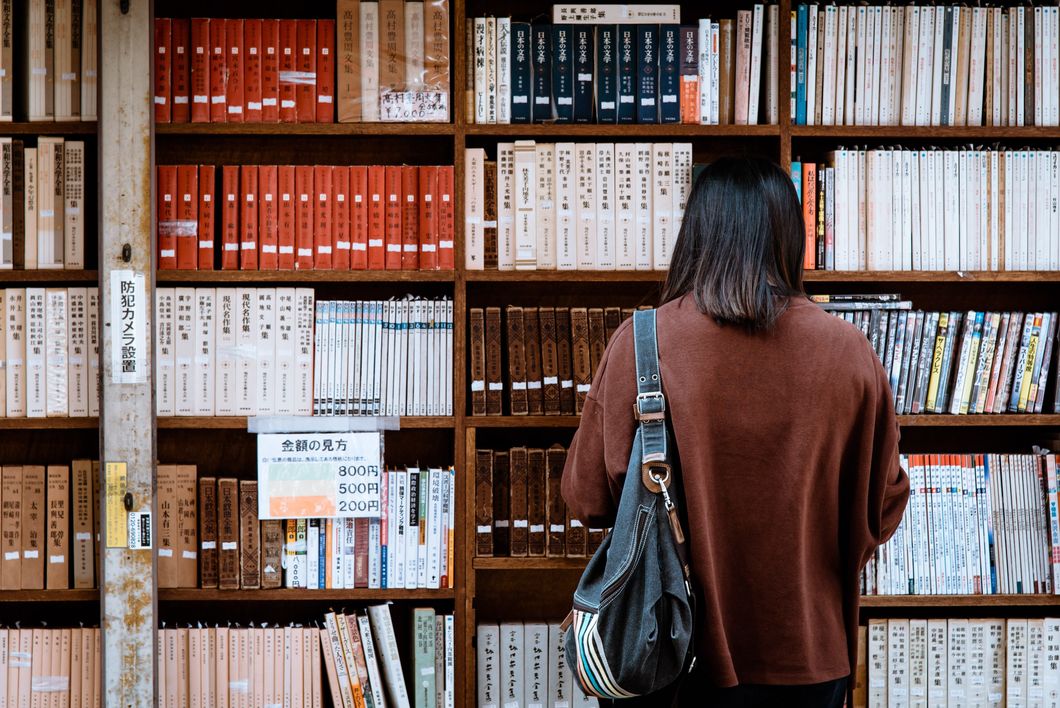 Woman in front of bookshelf