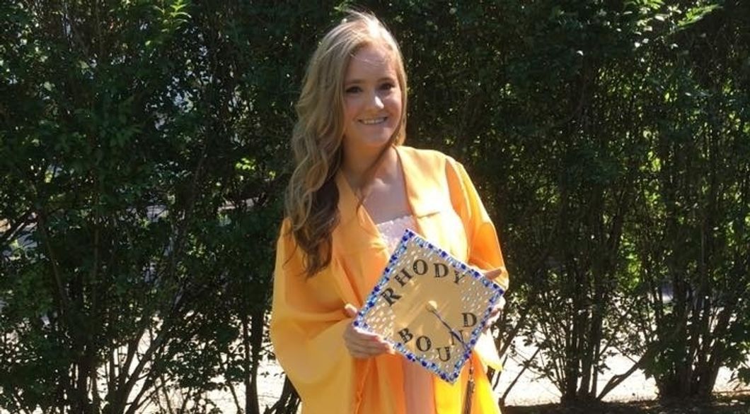 woman in high school graduation gown