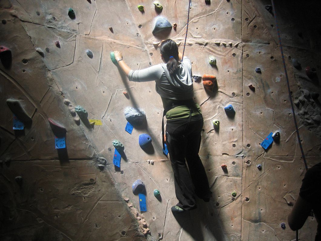 woman indoor rock climbing
