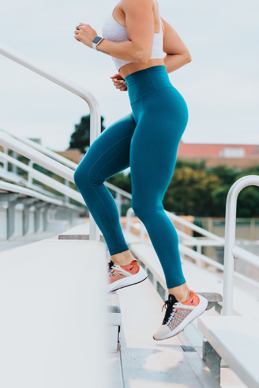 Woman jogging up a flight of steps for a cardio workout