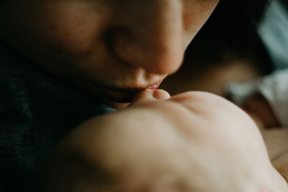 woman kissing child