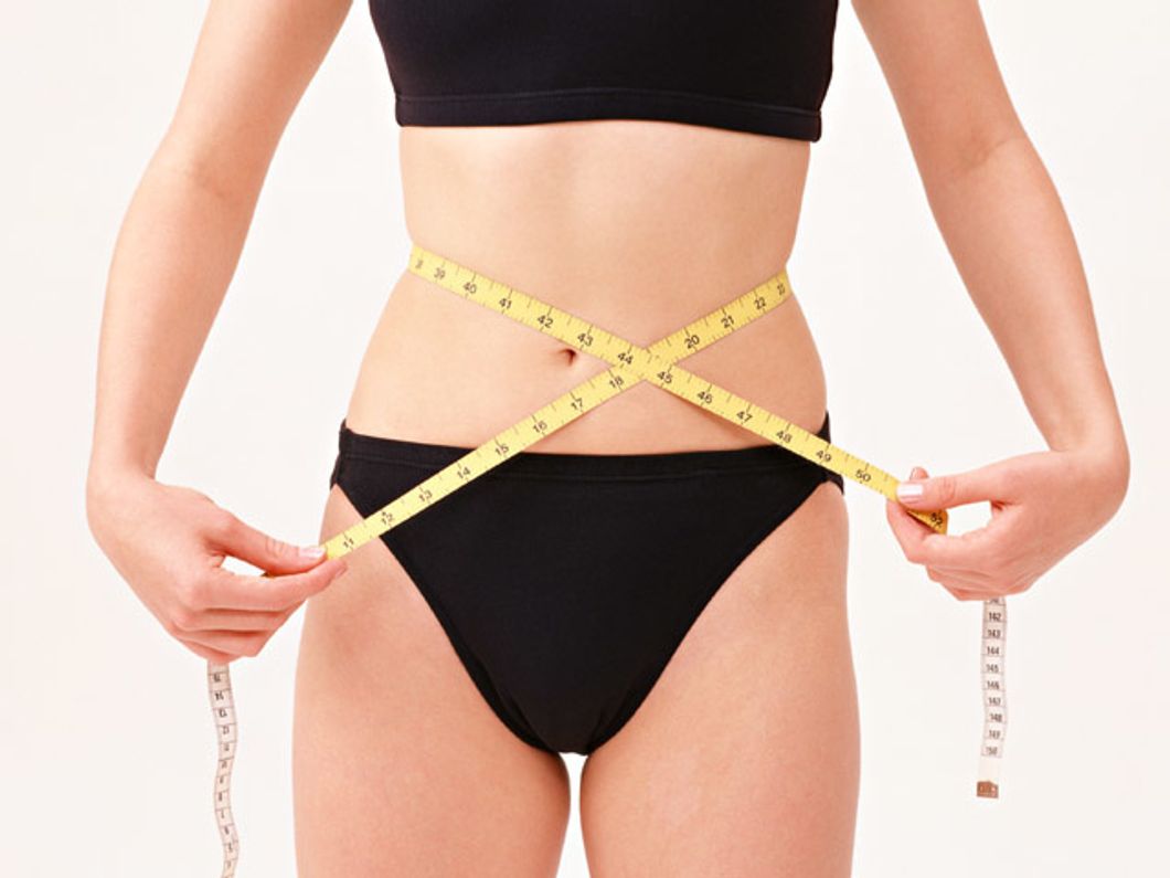 woman measuring waist tape measure