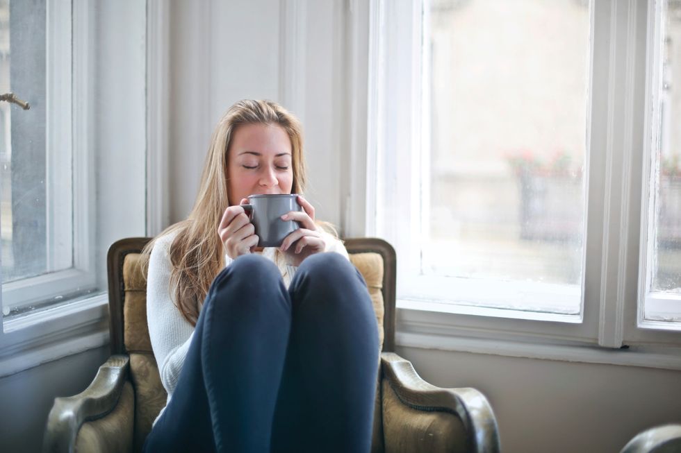 Woman relaxing in armchair