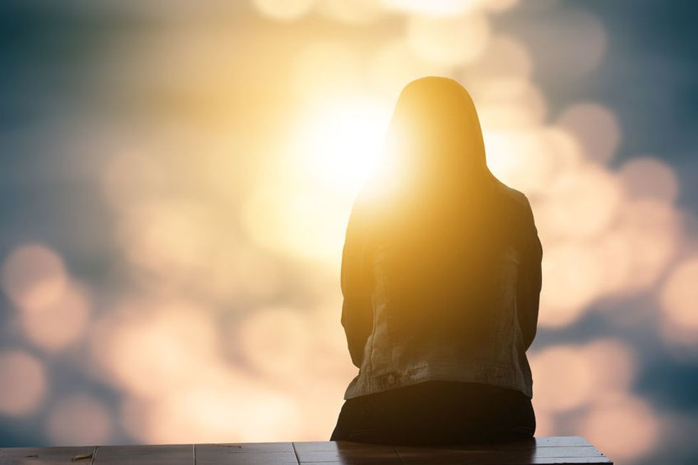 Woman sitting on wooden bench