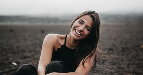 woman smiles in open field