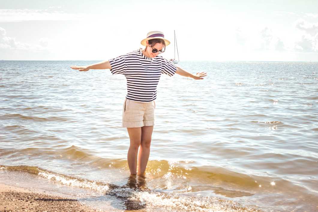 Woman standing at edge of water at beach