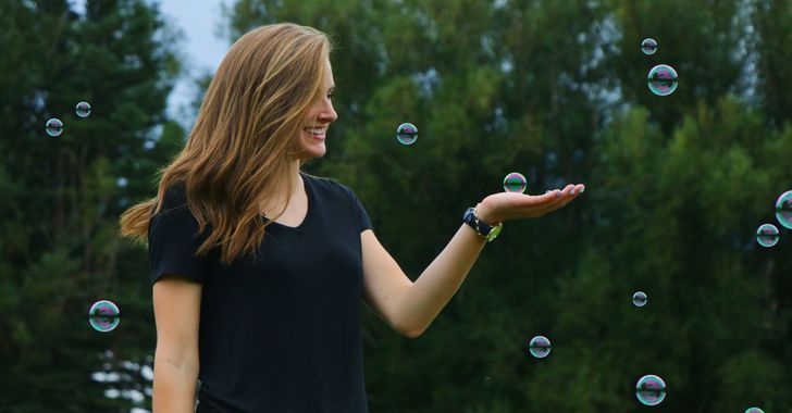 woman standing in front of bubbles playfully