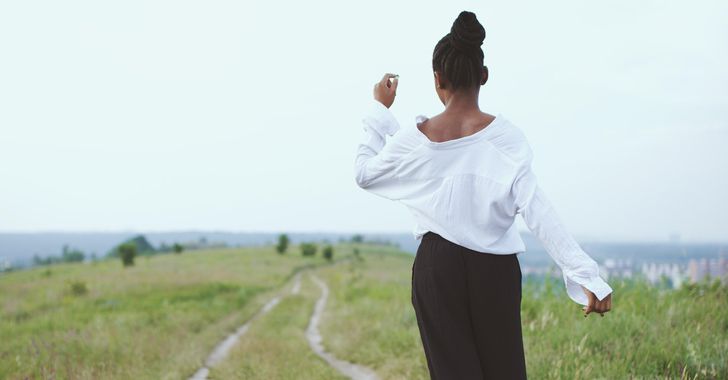 woman walks slowly in a field
