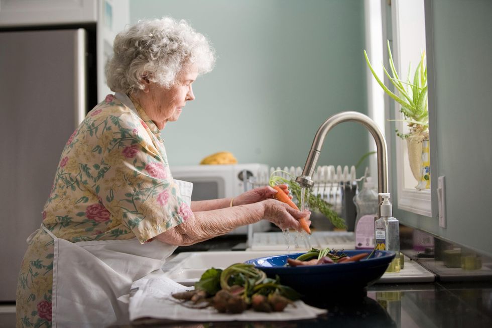 Woman washing vegetables