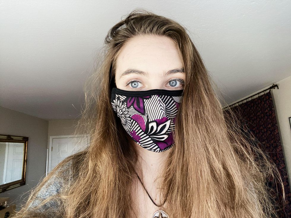 Woman wearing patterned face mask.