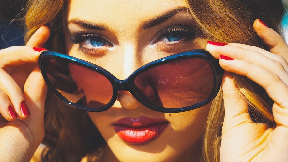 woman wearing rose colored glasses