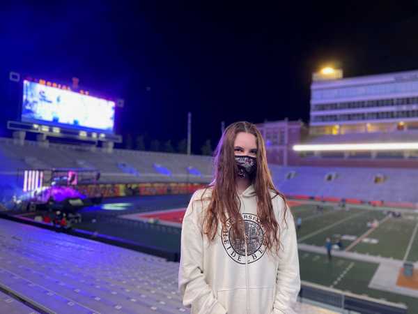 woman wears mask in a stadium