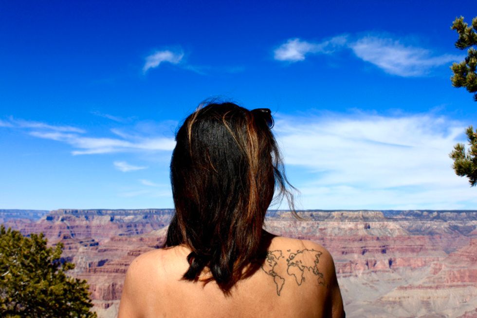 woman with atlas tattoo