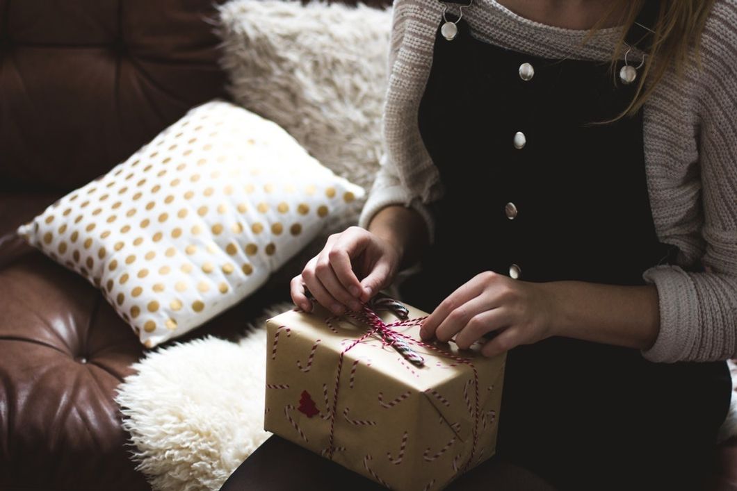 woman with christmas present on couch