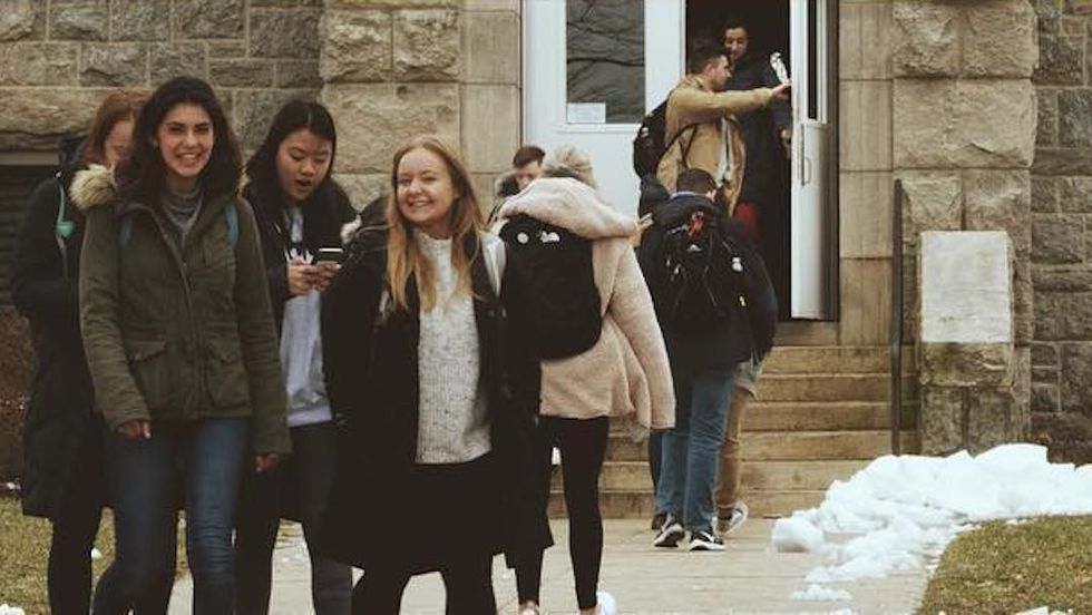 woman with glasses studying at table
