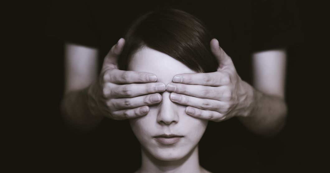 Woman with hands over her eyes 
