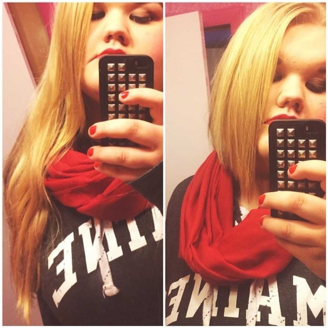 Woman with long and short hair taking mirror selfie on cell phone