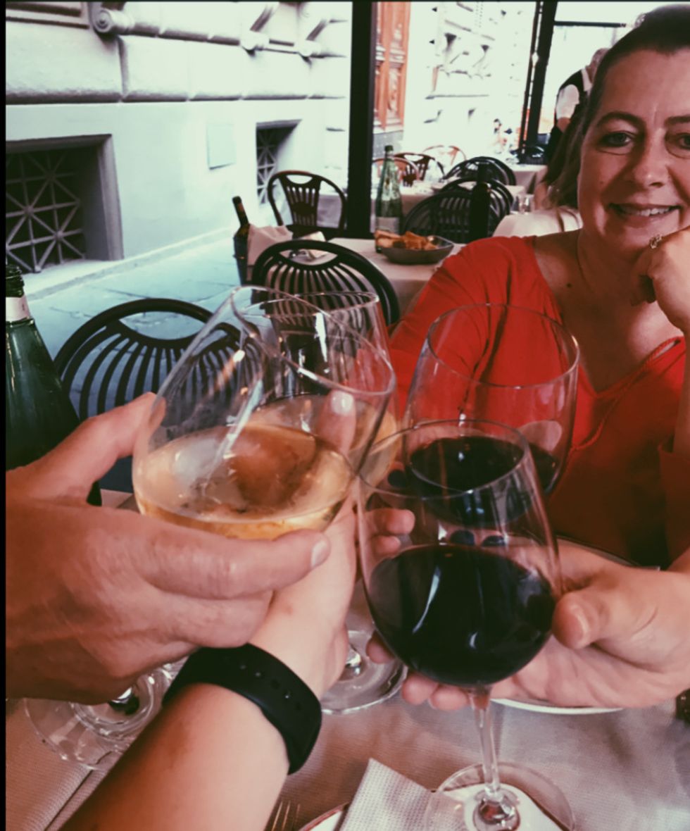 Women cheering with wine in Italy