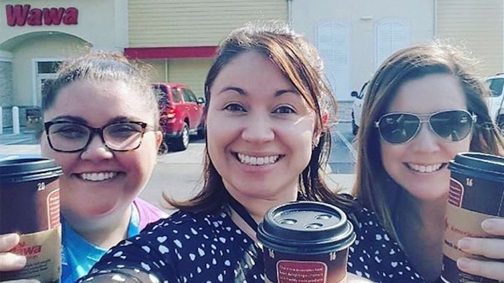 women eating wawa sandwiches drinking coffee
