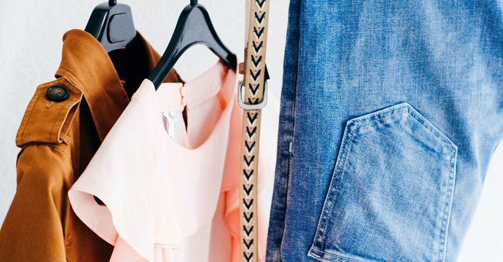 Women's four assorted apparel hanged on clothes rack