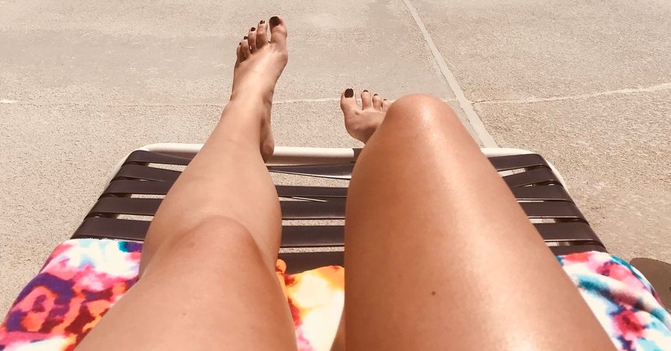 women sunbathing near pool on summer vacation