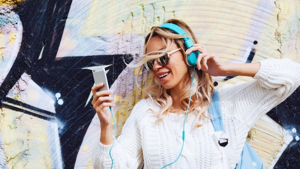 young beautiful woman listening to music on headphones