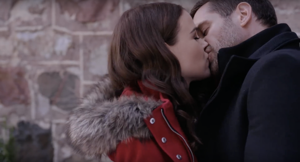 young couple kisses in christmas movie