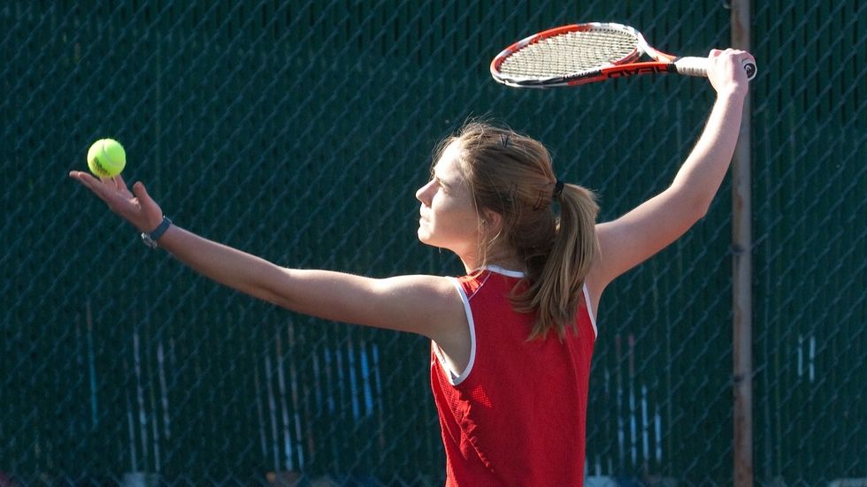 young girl playing tennis
