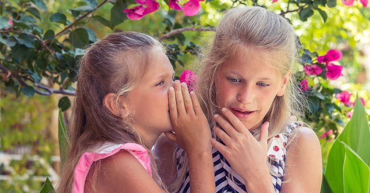 young girls gossip in a garden