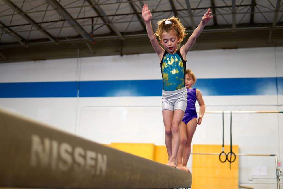 young gymnast does training