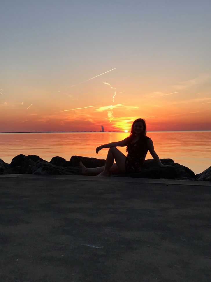 young woman in swimsuit on summer beach sunset