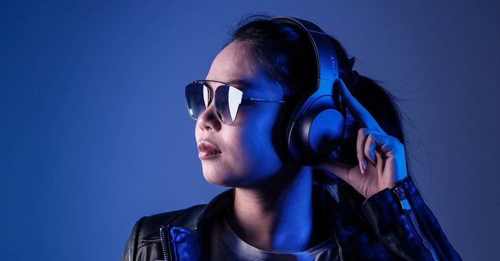young woman listening to music on headphones